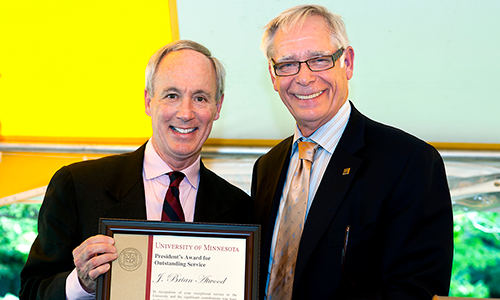 Provost Tom Sullivan poses with President Robert Bruininks. The provost is holding the certificate of recipient of J. Brian Atwood who was unable to attend the event.