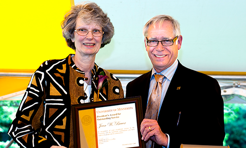 Jean W. Bauer poses with President Robert Bruininks. Bauer is holding her certificate.