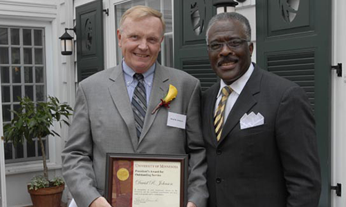 David R. Johnson poses with Robert Jones, Senior Vice President for Academic Administration. Johnson is holding his award certificate.