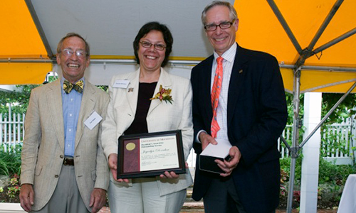 Joycelyn Dorscher poses with President Robert H. Bruininks and Professor Pete Magee. Dorscher is holding her award certificate.