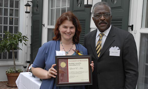 Laurel E. Hirt poses with Robert Jones, Senior Vice President for Academic Administration. Hirt is holding her award certificate.