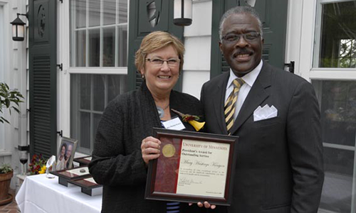 Mary Hastings Kenyon poses with Robert Jones, Senior Vice President for Academic Administration. Kenyon poses with her award certificate.