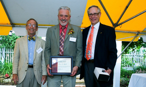 John O. Look poses with President Robert H. Bruininks and Professor Pete Magee. Look is holding his award certificate.