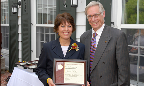 Jenny Meslow Recipient poses with President Robert H. Bruininks. Meslow is holding her award certificate.
