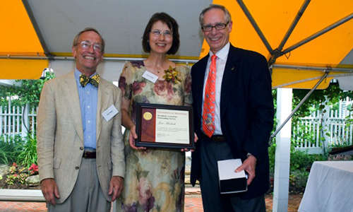 Jan Morlock poses with President Robert H. Bruininks and Professor Pete Magee. Morlock is holding her award certificate.
