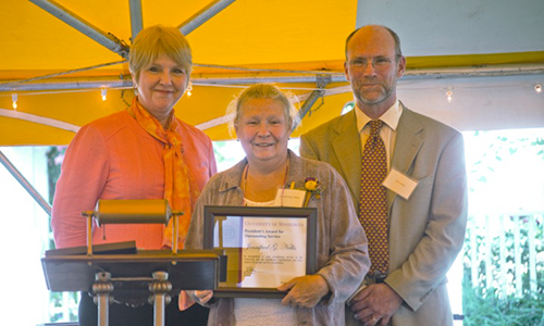 Jennifred G. Nellis poses with Executive Vice President and Provost Karen Hanson and Professor James Luby, chair of the President's Award for Outstanding Service Committee. Nellis is holding her certificate.