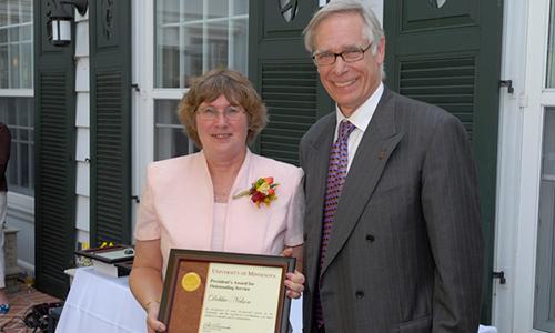Jenny Meslow Recipient poses with President Robert H. Bruininks. Nelson is holding her award certificate.