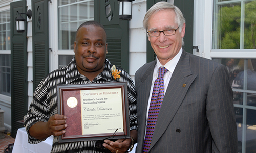 Charles Patterson poses with President Robert H. Bruininks. Meslow is holding his award certificate.