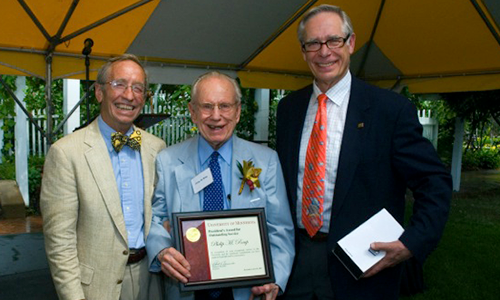 Philip M. Raup poses with President Robert H. Bruininks and Professor Pete Magee. Raup is holding his award certificate.