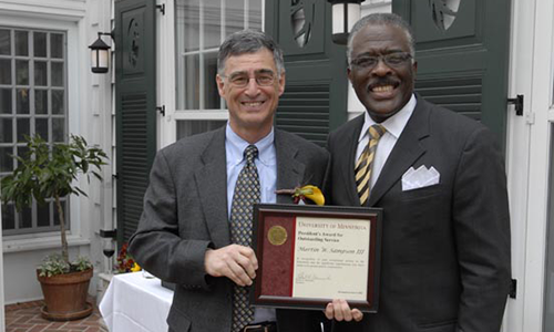 Martin W. Sampson III poses with Robert Jones, Senior Vice President for Academic Administration. Sampson holds his award certificate. 