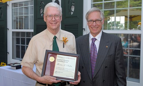 Thomas K. Soulen poses with President Robert H. Bruininks. Soulen is holding his award certificate.