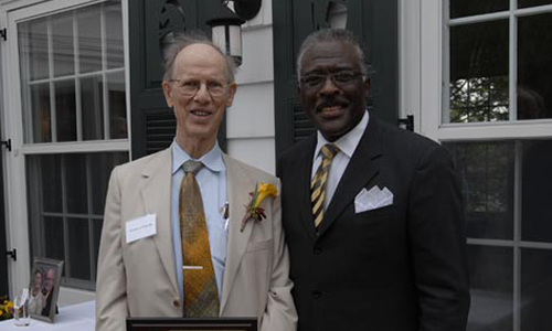 Warren J. Warwick poses with Robert Jones, Senior Vice President for Academic Administration. Warwick is holding his award certificate.