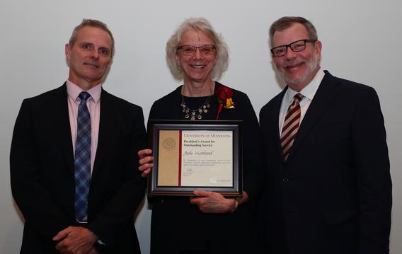 Recipient Julie Westlund receiving her award pictured with President Eric W. Kaler and Robert Geraghty, chair, President's Award committee.