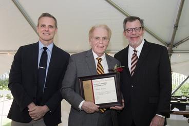 Mark Karon poses with President Eric Kaler and Professor Robert Geraghty, chair of the President's Award for Outstanding Service Committee. Karon is holding his certificate.