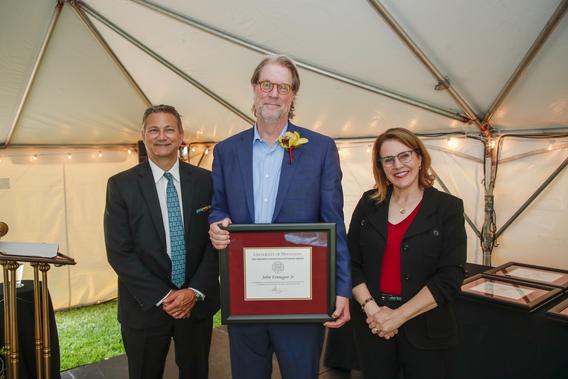 Photo of Professor Timothy Beebe with President Joan Gabel and Professor Mark Distefano, chair, President's Award for Outstanding Service Committee, receiving the award on behalf of John Finnegan Jr. who was unable to attend the reception