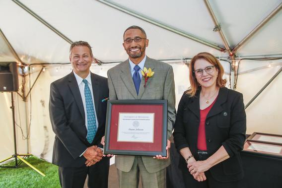 Photo of Duane Johnson with President Joan Gabel and Professor Mark Distefano, chair, President's Award for Outstanding Service Committee