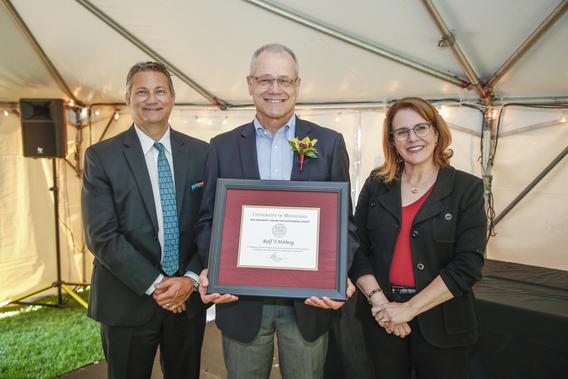Photo of Rolf T. Weberg with President Joan Gabel and Professor Mark Distefano, chair, President's Award for Outstanding Service Committee
