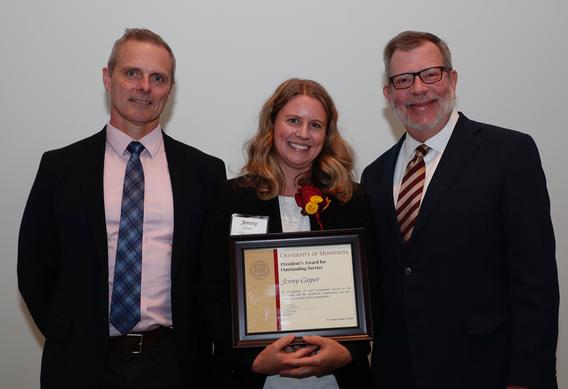 Recipient Jenny Caper receiving her award pictured with President Eric W. Kaler and Robert Geraghty, chair, President's Award committee.