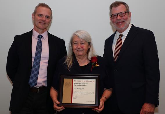 Recipient Maria Gini receiving her award pictured with President Eric W. Kaler and Robert Geraghty, chair, President's Award committee.