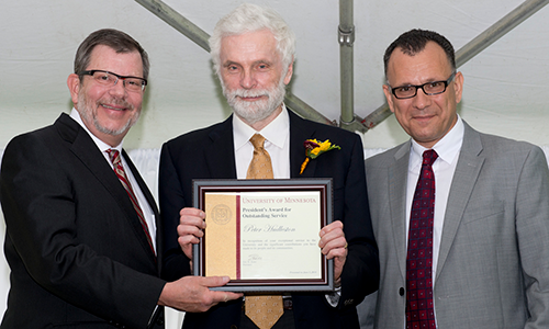 Peter Hudleston poses with President Eric Kaler and Professor Fotis Sotiropoulos, representing the President's Award for Outstanding Service Committee. Hudleston is holding his certificate.