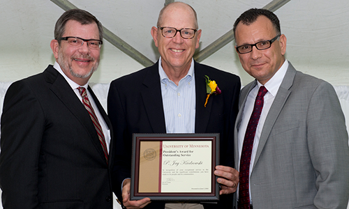 P. Jay Kiedrowski poses with President Eric Kaler and Professor Fotis Sotiropoulos, representing the President's Award for Outstanding Service Committee. Kiedrowski is holding his certificate.