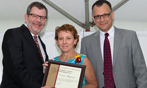 Connie Magnuson poses with President Eric Kaler and Professor Fotis Sotiropoulos, representing the President's Award for Outstanding Service Committee. Magnuson is holding her certificate.