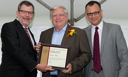 Jerry Meier poses with President Eric Kaler and Professor Fotis Sotiropoulos, representing the President's Award for Outstanding Service Committee. Meier is holding his certificate.