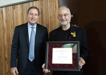 Interim President Jeff Ettinger and Howard Oransky holding framed citation